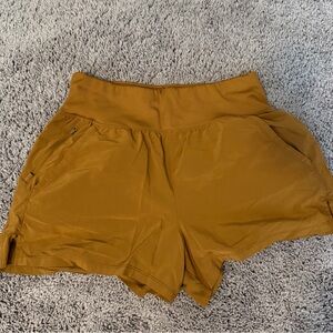 all in motion Women's High-Rise Athletic Shorts in Mustard